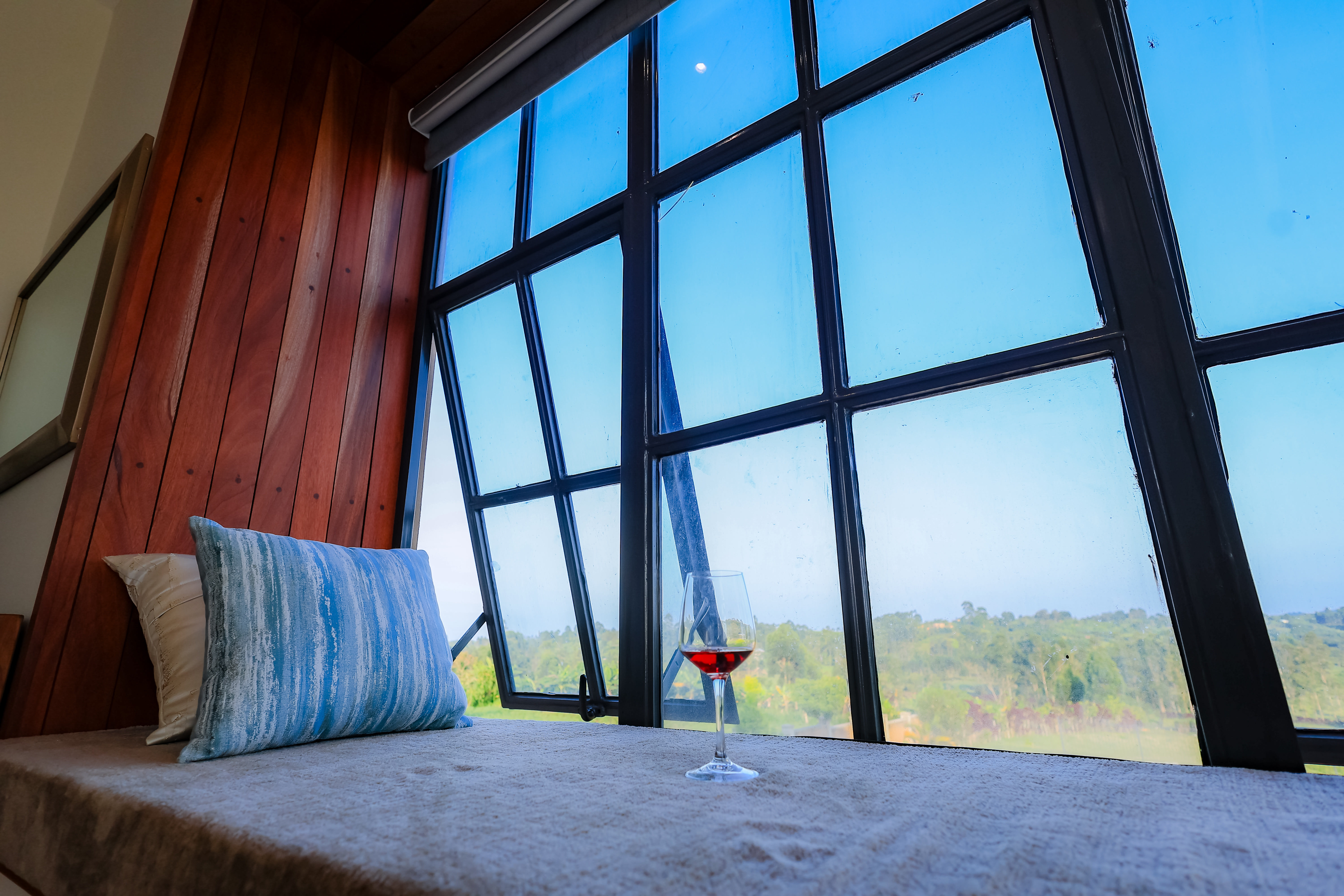 Cozy bay window seating area overlooking the lush garden